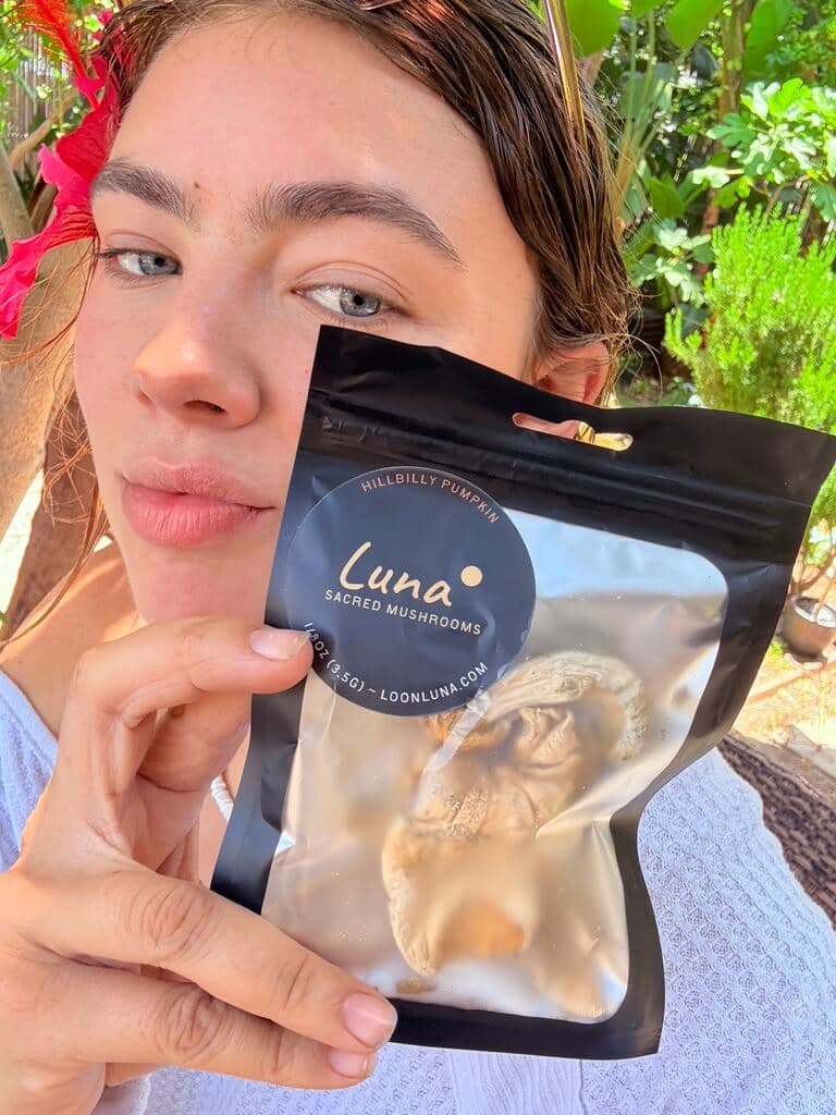 Charli holding a bag of Luna mushrooms